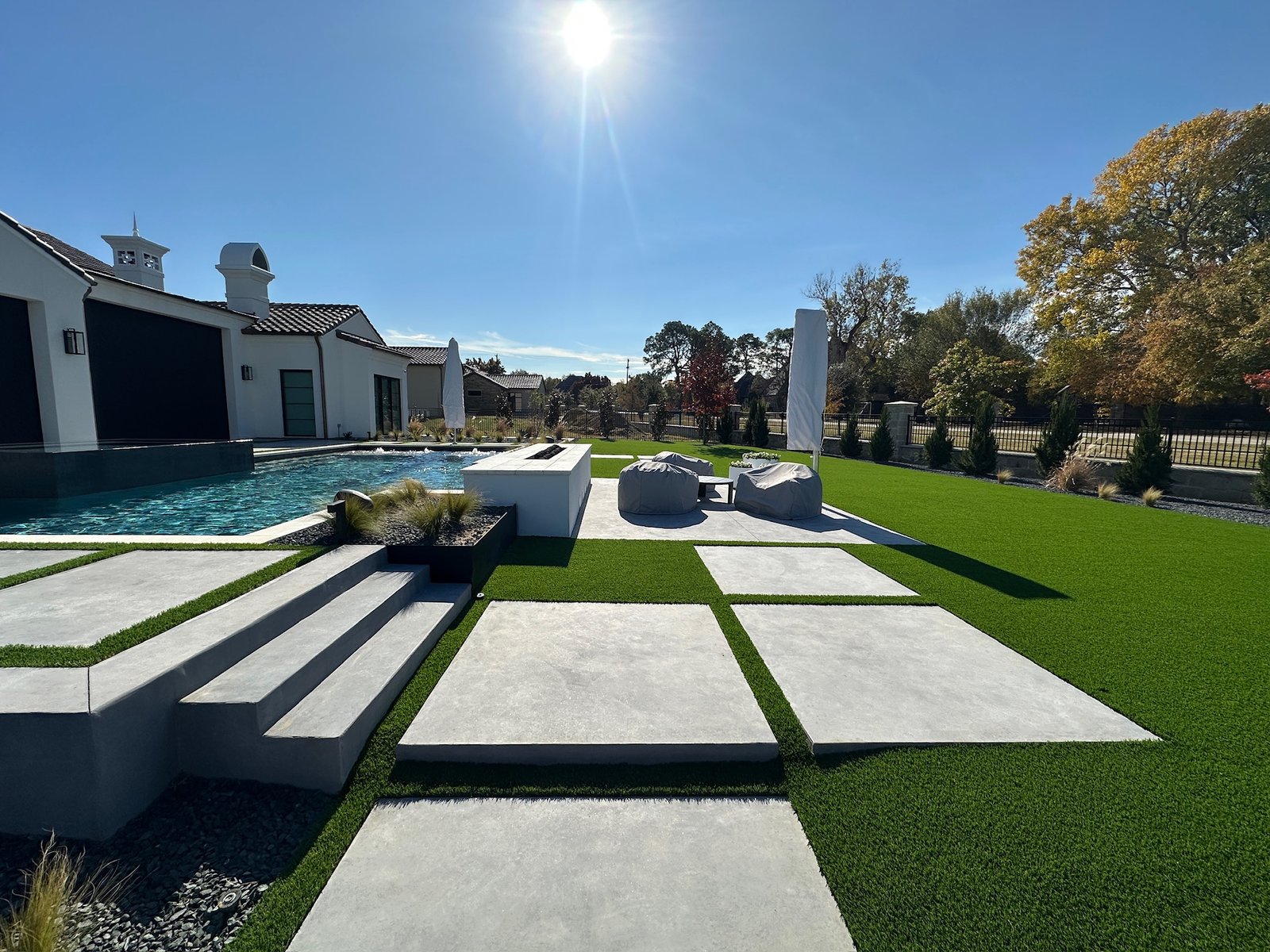 Modern Dallas backyard with artificial turf installation designed to stay cooler during summer heat