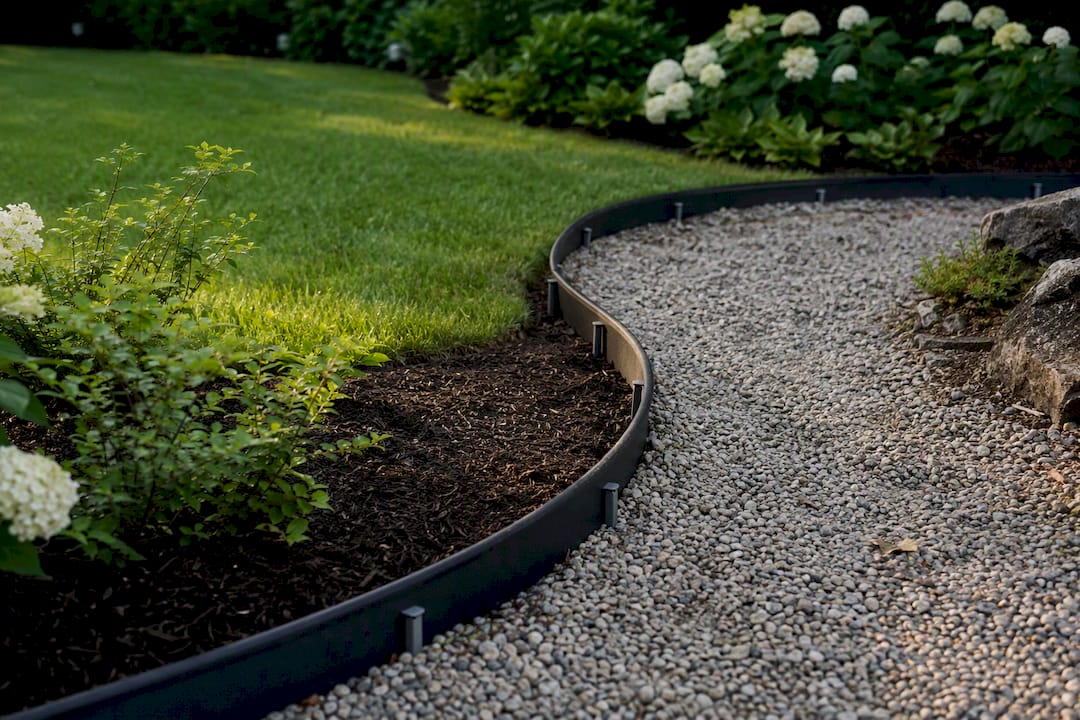 Flexible plastic edging on curved garden path