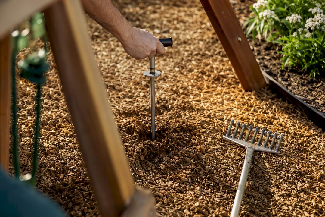 Hand checking loose-fill playground surface depth