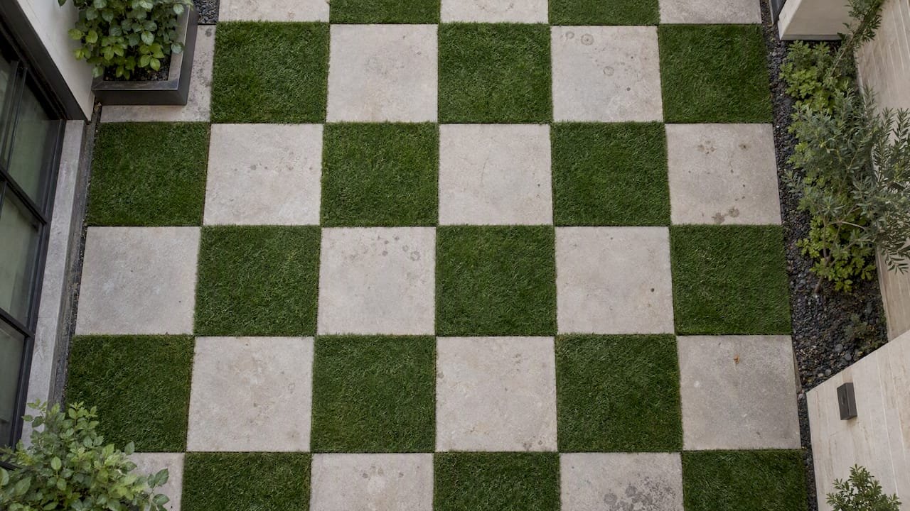 Checkerboard grid of turf and square pavers